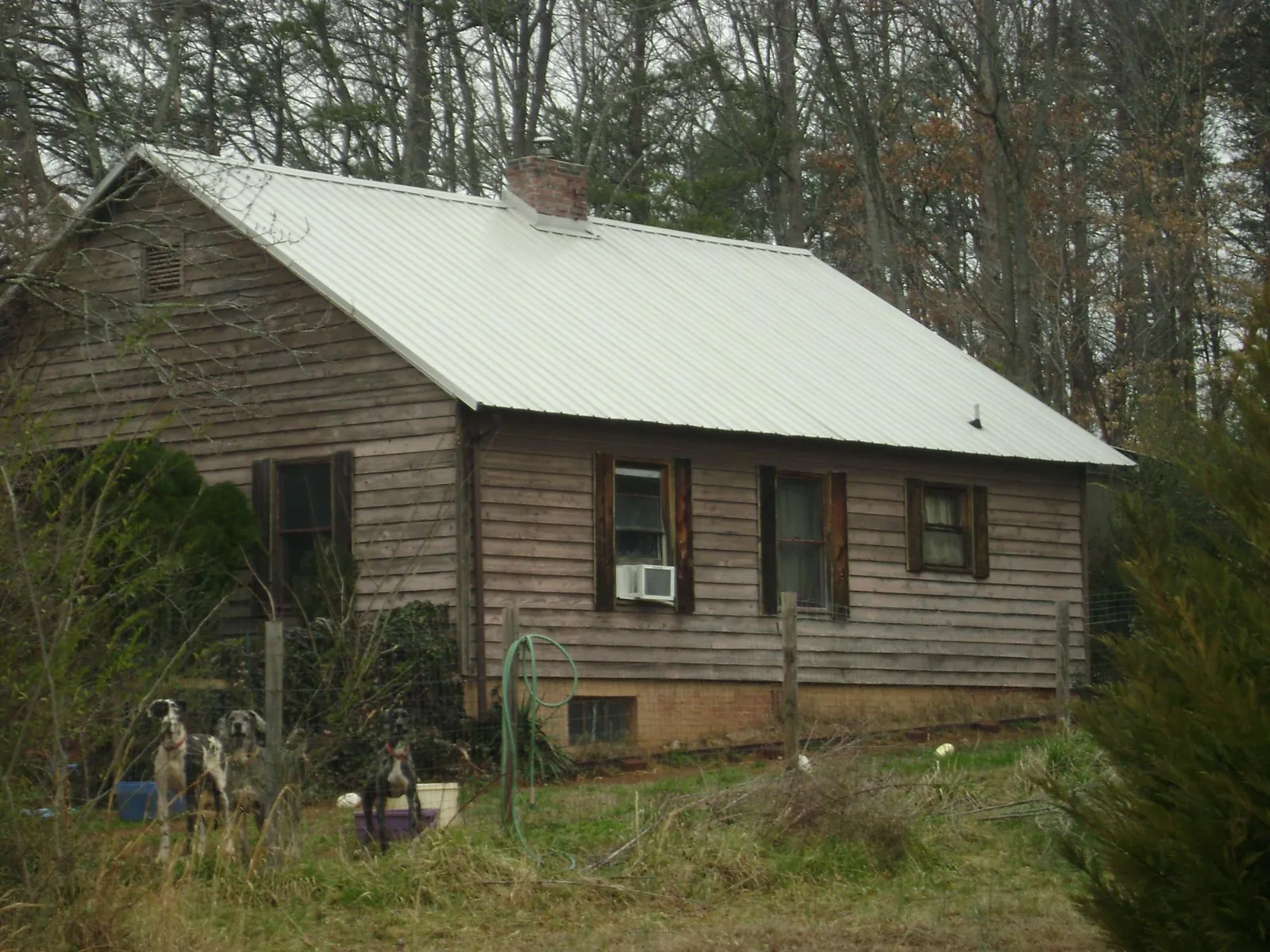 White metal roof on an old wood sided farmhouse, from a Metal Roof Installation job in Karthaus